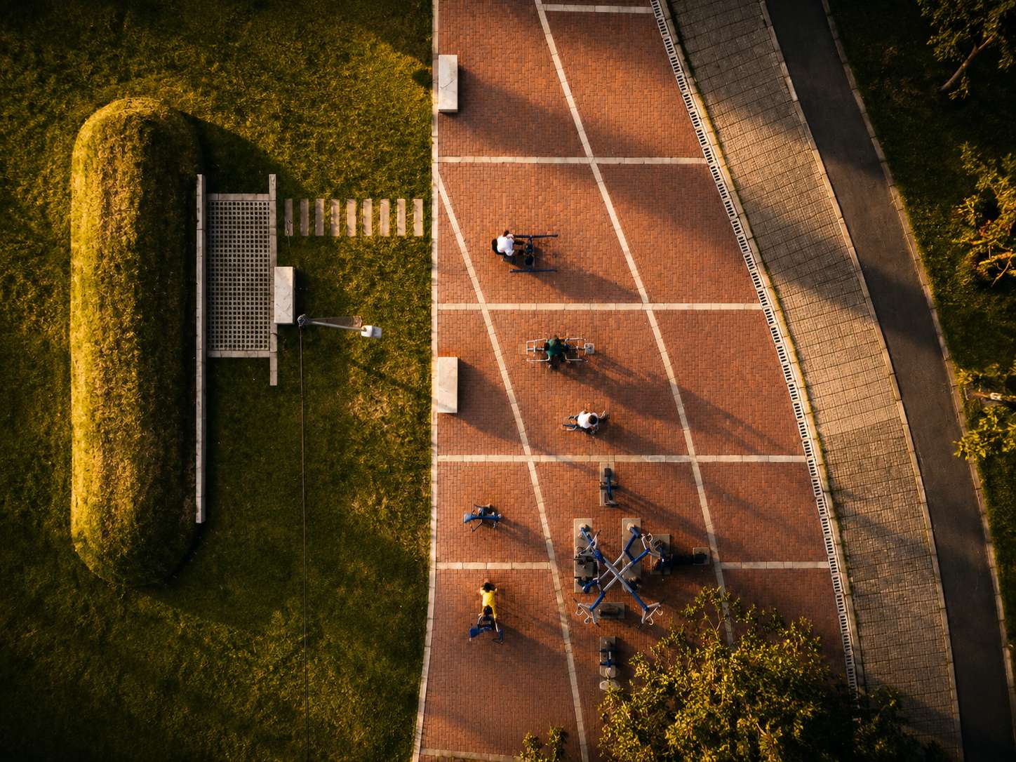 Central pedestrian pathway connecting recreation areas through accessible and sustainable public space design.